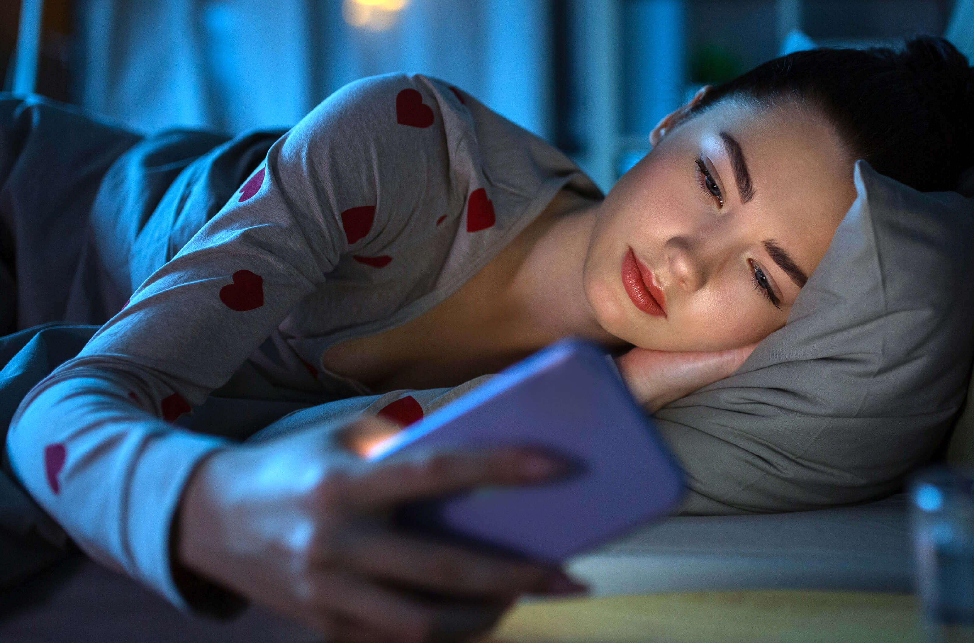 Girl checking her phone set to DND at night